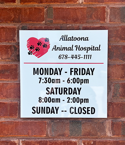 Store front business hours sign in Woodstock, Georgia
