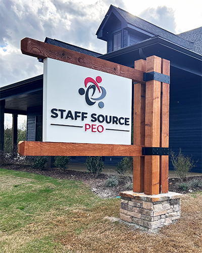 Monument post and panel sign made with natural materials of wood and stone